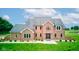 Beautiful two-story brick home featuring a manicured front lawn, mature landscaping, and an inviting entryway at 8371 N 400 W, Fairland, IN 46126