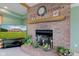 Close-up of a brick fireplace with mantel decor, enhancing the living room's cozy atmosphere at 8371 N 400 W, Fairland, IN 46126
