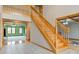 Open foyer with a wooden staircase and views into adjacent rooms with high ceilings and natural light at 8371 N 400 W, Fairland, IN 46126