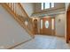 Welcoming foyer with tiled flooring, wooden staircase, and a front door featuring decorative glass at 8371 N 400 W, Fairland, IN 46126