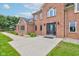 Close up view of a brick home featuring a front door with decorative glass and well-groomed landscaping at 8371 N 400 W, Fairland, IN 46126