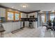 Well-lit kitchen features stainless steel appliances, including a stove, microwave, and cozy dining area with tile flooring at 8371 N 400 W, Fairland, IN 46126