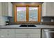 Kitchen with a deep sink, modern fixtures, granite countertops, and white cabinetry under a natural wood frame window at 8371 N 400 W, Fairland, IN 46126