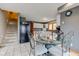 Bright kitchen features a staircase, modern appliances, white cabinetry, and a stylish dining area with glass table at 8371 N 400 W, Fairland, IN 46126