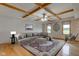 Staged living room with area rug, sectional sofa, and wood-beamed ceiling at 8371 N 400 W, Fairland, IN 46126