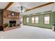 Spacious living room with brick fireplace, wooden beams, and large windows offering abundant natural light at 8371 N 400 W, Fairland, IN 46126