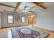 Spacious living room featuring hardwood floors, two windows, a decorative mirror, and wood-beamed ceiling at 8371 N 400 W, Fairland, IN 46126