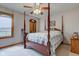 Comfortable main bedroom features a canopy bed, ceiling fan and natural light at 8371 N 400 W, Fairland, IN 46126