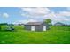Aerial view of an outbuilding in a spacious yard, offering ample storage or workshop potential at 8371 N 400 W, Fairland, IN 46126