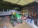 Interior of a garage showing a tractor and boat, with ample space for vehicles and equipment at 8371 N 400 W, Fairland, IN 46126