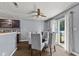 Dining room with stylish table, a ceiling fan, and sliding door access to the backyard at 9125 Timpani Way, Indianapolis, IN 46231