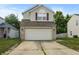 Two-story home featuring a two-car garage and concrete driveway, providing ample parking at 9125 Timpani Way, Indianapolis, IN 46231