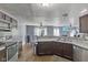 Open kitchen featuring stainless steel appliances, a stylish backsplash and wood-look floors at 9125 Timpani Way, Indianapolis, IN 46231