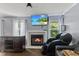 Cozy living room featuring a fireplace and a wall-mounted TV at 9125 Timpani Way, Indianapolis, IN 46231