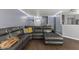 Spacious living room featuring a large sectional sofa and wood-look floors at 9125 Timpani Way, Indianapolis, IN 46231