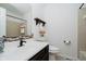 Well lit bathroom featuring mosaic tiles, dark cabinets, and shower with an updated shower head at 9363 Hadway Dr, Indianapolis, IN 46256