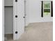 Bright bedroom featuring neutral carpet, a large window, and a closet with an open door at 9363 Hadway Dr, Indianapolis, IN 46256