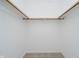Empty closet with carpeted floor, white walls, and a wooden rod for hanging clothing at 9363 Hadway Dr, Indianapolis, IN 46256