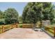 Outdoor wooden deck with seating, perfect for relaxing and overlooking the scenic, tree-filled backyard at 9363 Hadway Dr, Indianapolis, IN 46256