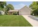 Charming single-story home featuring a well-maintained lawn, manicured landscaping, and an attached two-car garage at 9363 Hadway Dr, Indianapolis, IN 46256
