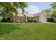 Inviting home showcasing lush green lawn, mature trees, and a blend of siding and brick exterior accents at 9363 Hadway Dr, Indianapolis, IN 46256