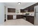 Functional kitchen featuring dark cabinets, stainless steel appliances, and a tile backsplash at 9363 Hadway Dr, Indianapolis, IN 46256