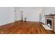 Inviting living room with hardwood floors, a corner fireplace, and ample space for comfortable seating at 9363 Hadway Dr, Indianapolis, IN 46256