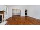 Open-concept living area with hardwood floors, fireplace, and seamless flow to dining and kitchen areas at 9363 Hadway Dr, Indianapolis, IN 46256
