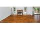 Spacious living room featuring hardwood floors, a cozy fireplace, and large windows for natural light at 9363 Hadway Dr, Indianapolis, IN 46256