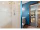 Bathroom featuring a tiled shower and a white vanity with a blue accent wall at 9458 Dawn Dr, Brownsburg, IN 46112