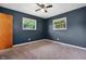 This cozy bedroom features two bright windows, neutral carpet, and freshly painted walls at 9458 Dawn Dr, Brownsburg, IN 46112