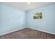 Cozy bedroom with a gray carpet, a window, and a light blue painted wall at 9458 Dawn Dr, Brownsburg, IN 46112