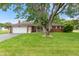 Charming brick ranch home featuring an attached garage, a manicured lawn, and mature shade trees at 9458 Dawn Dr, Brownsburg, IN 46112