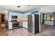 This stylish kitchen features stainless steel appliances, modern two-tone cabinetry, and wood grain flooring at 9458 Dawn Dr, Brownsburg, IN 46112