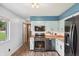 This stylish kitchen features stainless steel appliances, modern two-tone cabinetry, and wood grain flooring at 9458 Dawn Dr, Brownsburg, IN 46112