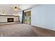 This comfortable living room features a brick fireplace, neutral carpet, and a sliding glass door to the backyard at 9458 Dawn Dr, Brownsburg, IN 46112