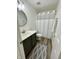 Well-appointed bathroom with a dark vanity, round mirror and new fixtures at 9664 Legare St # 2601, Fishers, IN 46038