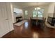 Dining area features hardwood floors, stylish table and chairs, plus a view into the kitchen, and access to the backyard at 9664 Legare St # 2601, Fishers, IN 46038