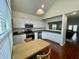 Well-lit kitchen featuring modern stainless steel appliances, light countertops, and a view of the living room at 9664 Legare St # 2601, Fishers, IN 46038