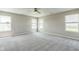A spacious bedroom features three windows and neutral carpet at 9692 Centennial Ct, Avon, IN 46123