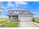 Charming two-story home featuring gray siding, a brick accent wall, and a two-car garage at 9692 Centennial Ct, Avon, IN 46123