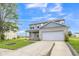 Charming two-story home featuring gray siding, a brick accent wall, and a two-car garage at 9692 Centennial Ct, Avon, IN 46123