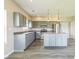 A modern kitchen boasts an island and stainless steel appliances at 9692 Centennial Ct, Avon, IN 46123