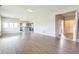 Open-concept living room showcasing hardwood floors with kitchen and staircase access at 9692 Centennial Ct, Avon, IN 46123