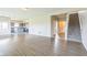 Open-concept living room showcasing hardwood floors with kitchen and staircase access at 9692 Centennial Ct, Avon, IN 46123