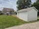 View of detached garage and back of house with grass lawn at 1033 Cottage Ave, Columbus, IN 47201