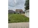 Backyard featuring grass lawn, the rear of the house and a detached garage at 1033 Cottage Ave, Columbus, IN 47201