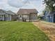 View of the backyard featuring green lawn and rear of home with porch at 1033 Cottage Ave, Columbus, IN 47201