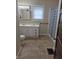 Bathroom features double sink vanity and shower with patterned curtain at 1033 Cottage Ave, Columbus, IN 47201