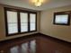 Bedroom featuring hardwood floors and large windows that flood the room with light at 1033 Cottage Ave, Columbus, IN 47201
